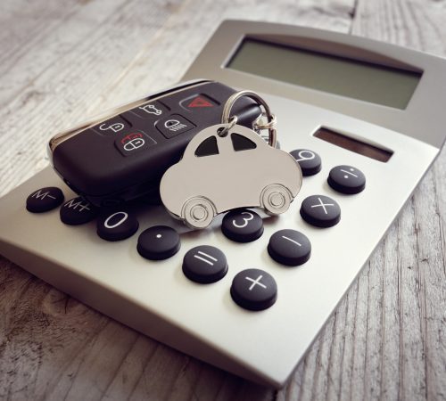 Car shape keyring and key on calculator